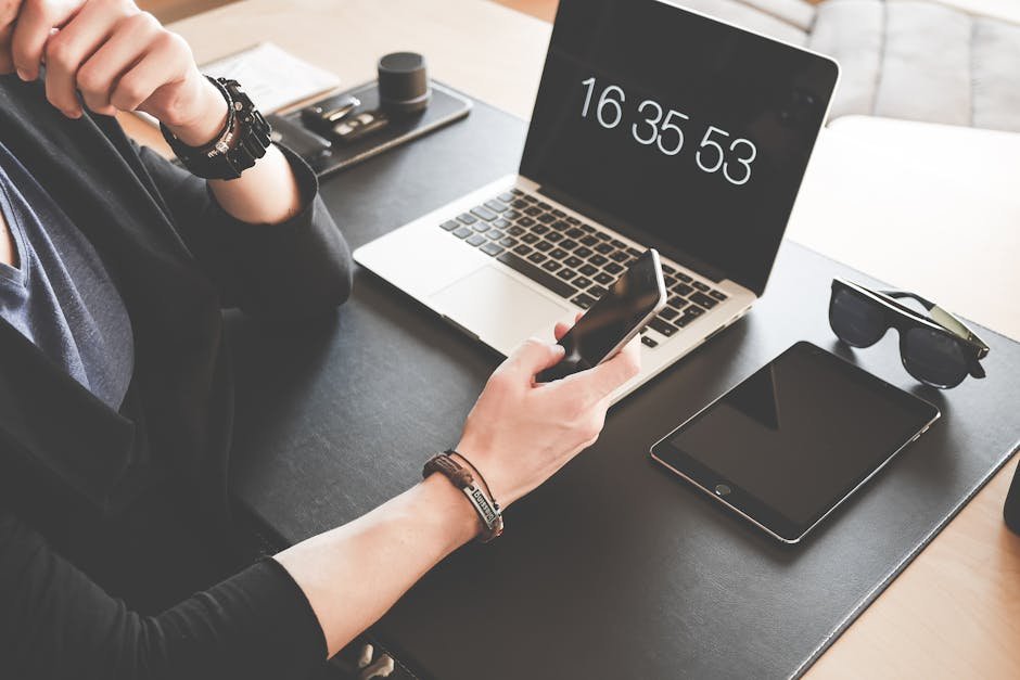 pexels-photo-196656-196656 Woman Using a Smartphone While Fronting a Macbook Pro and Black Ipad